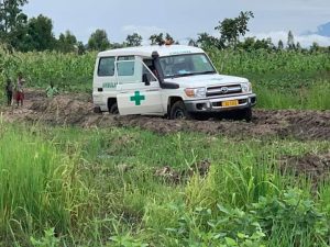 A medical vehicle stuck in heavy mud.